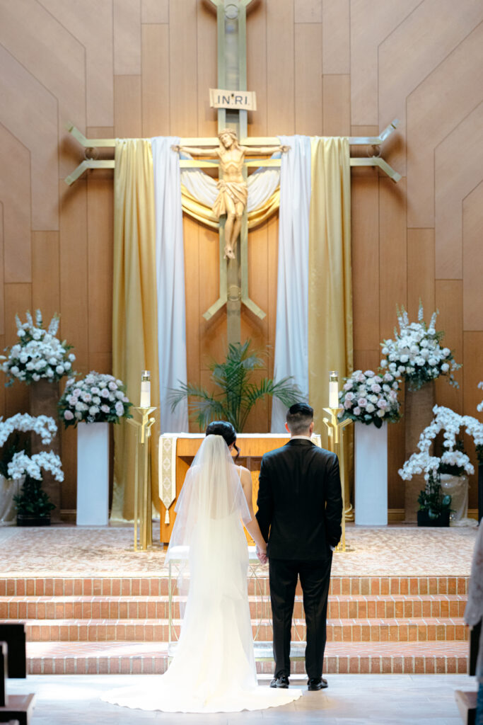 bride and groom at altar at holy spirit catholic shurch