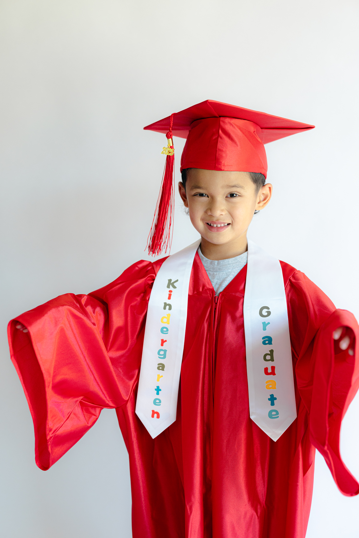 Child in cap and gown for kindergarten photo shoot
